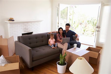 simsearch:400-08938320,k - Family Take A Break On Sofa Using Laptop On Moving Day Stock Photo - Budget Royalty-Free & Subscription, Code: 400-08838171