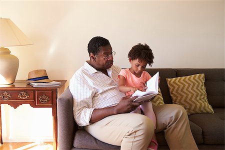 Grandfather And Granddaughter Reading Book At Home Together Stock Photo - Budget Royalty-Free & Subscription, Code: 400-08838202