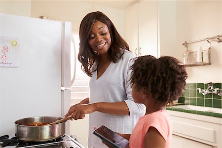 Mother And Daughter At Home Preparing Meal In Kitchen Stock Photo - Budget Royalty-Free & Subscription, Code: 400-08838243