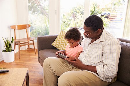 Grandfather And Granddaughter At Home Using Digital Tablet Stock Photo - Budget Royalty-Free & Subscription, Code: 400-08838255