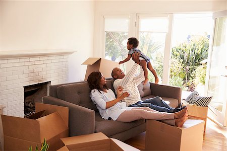 simsearch:400-08938320,k - Parents Take A Break On Sofa With Son On Moving Day Stock Photo - Budget Royalty-Free & Subscription, Code: 400-08838274