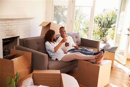 Couple On Sofa Taking A Break From Unpacking On Moving Day Stock Photo - Budget Royalty-Free & Subscription, Code: 400-08838273