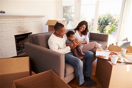 simsearch:400-08938320,k - Family Take A Break On Sofa With Pizza On Moving Day Stock Photo - Budget Royalty-Free & Subscription, Code: 400-08838282