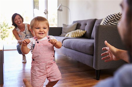 first steps mother - Parents Watching Baby Daughter Take First Steps At Home Stock Photo - Budget Royalty-Free & Subscription, Code: 400-08838366