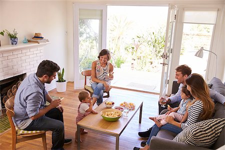 simsearch:400-05686620,k - Two Families Getting Together At Home Stock Photo - Budget Royalty-Free & Subscription, Code: 400-08838371