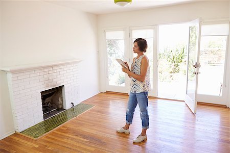 Female Realtor With Digital Tablet Looking Around House Stock Photo - Budget Royalty-Free & Subscription, Code: 400-08838399