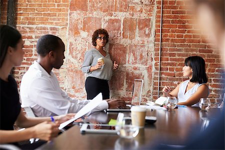 Mature Businesswoman Standing To Address Boardroom Meeting Stock Photo - Budget Royalty-Free & Subscription, Code: 400-08838670