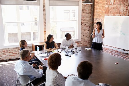 Businesswoman At Whiteboard Giving Presentation In Boardroom Stock Photo - Budget Royalty-Free & Subscription, Code: 400-08838680