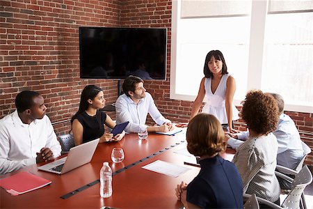 Businesswoman Addressing Boardroom Meeting Foto de stock - Royalty-Free Super Valor e Assinatura, Número: 400-08838732