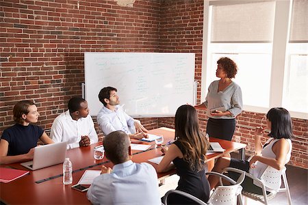 Mature Businesswoman Addressing Boardroom Meeting Foto de stock - Royalty-Free Super Valor e Assinatura, Número: 400-08838749