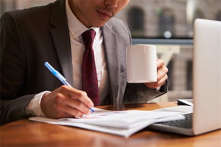 simsearch:400-08838924,k - Businessman working on document holding coffee mug, close up Stock Photo - Budget Royalty-Free & Subscription, Code: 400-08838788