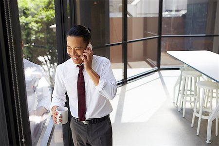 simsearch:400-08838779,k - Happy Asian businessman on the phone in modern office Stock Photo - Budget Royalty-Free & Subscription, Code: 400-08838795