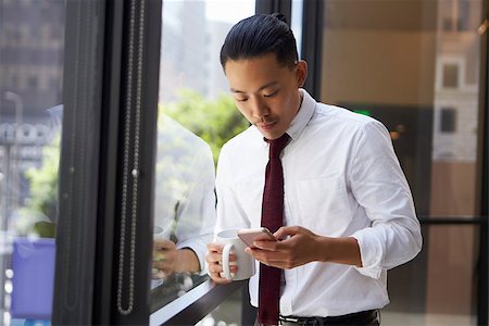 simsearch:400-08838779,k - Asian businessman using phone in modern office, close up Stock Photo - Budget Royalty-Free & Subscription, Code: 400-08838793