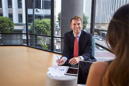 simsearch:400-08838779,k - Young businessman and woman talking at an informal meeting Stock Photo - Budget Royalty-Free & Subscription, Code: 400-08838834