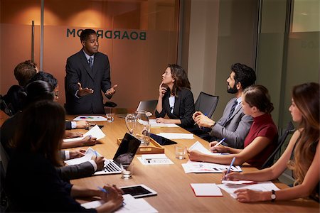simsearch:400-08838985,k - Black businessman standing to address colleagues at meeting Stock Photo - Budget Royalty-Free & Subscription, Code: 400-08838865
