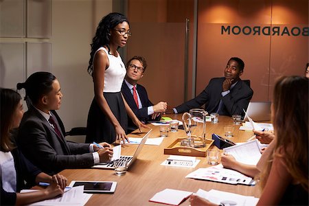 simsearch:400-08838985,k - Black businesswoman stands addressing colleagues at meeting Stock Photo - Budget Royalty-Free & Subscription, Code: 400-08838866