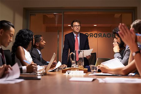 simsearch:400-08838985,k - Businessman stands addressing team at meeting, low angle Stock Photo - Budget Royalty-Free & Subscription, Code: 400-08838872