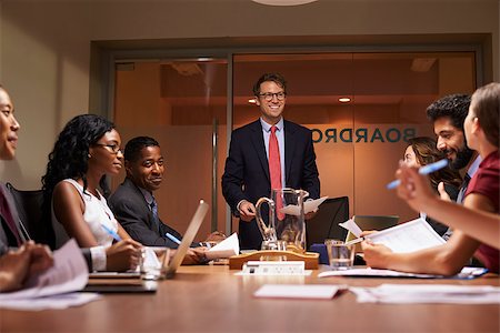 simsearch:400-08838985,k - Smiling businessman addressing team at meeting, low angle Stock Photo - Budget Royalty-Free & Subscription, Code: 400-08838873