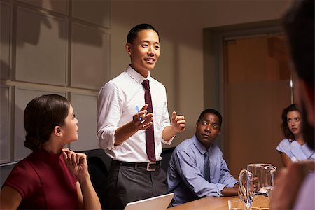simsearch:400-08838985,k - Asian businessman standing to address colleagues at meeting Stock Photo - Budget Royalty-Free & Subscription, Code: 400-08838885