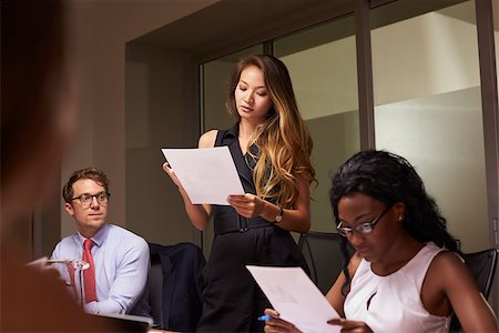 simsearch:400-08838985,k - Woman stands reading document at an evening business meeting Stock Photo - Budget Royalty-Free & Subscription, Code: 400-08838887