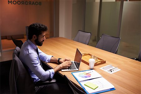 Hispanic businessman working late in office, elevated view Stock Photo - Budget Royalty-Free & Subscription, Code: 400-08838915