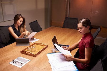 simsearch:400-08838779,k - Two businesswomen doing paperwork late in an office Stock Photo - Budget Royalty-Free & Subscription, Code: 400-08838935