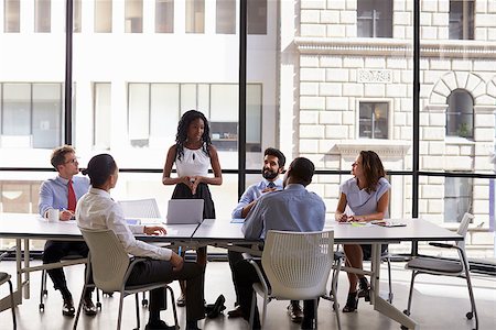 simsearch:400-08838985,k - Young black businesswoman addressing colleagues at a meeting Stock Photo - Budget Royalty-Free & Subscription, Code: 400-08838976