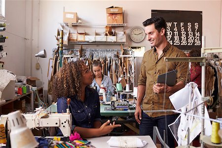 female native american clothing - Colleagues talk at a clothes manufacturing studio, close up Foto de stock - Super Valor sin royalties y Suscripción, Código: 400-08839036