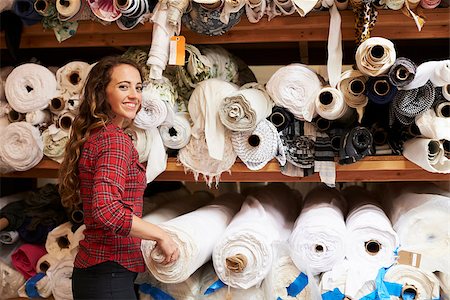 fashion store manager - Young white woman selecting fabrics looking to camera Stock Photo - Budget Royalty-Free & Subscription, Code: 400-08839057