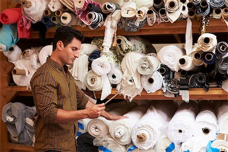 fashion store manager - Man using tablet selects fabric from storage shelves Stock Photo - Budget Royalty-Free & Subscription, Code: 400-08839059