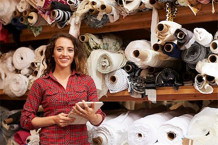 fashion store manager - Woman using tablet in fabric storage warehouse, portrait Stock Photo - Budget Royalty-Free & Subscription, Code: 400-08839062