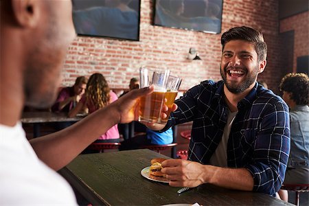 Friends Eating Out In Sports Bar With Screens In Background Stock Photo - Budget Royalty-Free & Subscription, Code: 400-08839144
