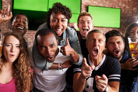 friends smiling 30 beer - Portrait Of Friends Watching Game In Sports Bar On Screens Stock Photo - Budget Royalty-Free & Subscription, Code: 400-08839140