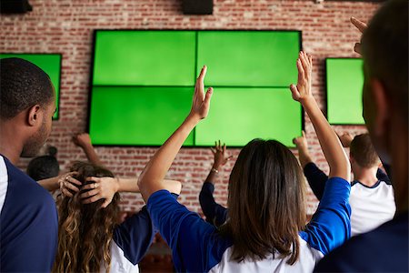 Rear View Of Disappointed Friends Watching Game In Sport Bar Stock Photo - Budget Royalty-Free & Subscription, Code: 400-08839156