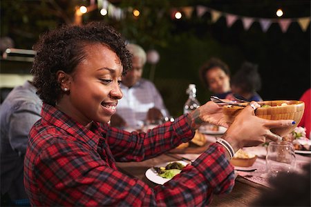 Young black woman passing bowl at a family barbecue Stock Photo - Budget Royalty-Free & Subscription, Code: 400-08839258