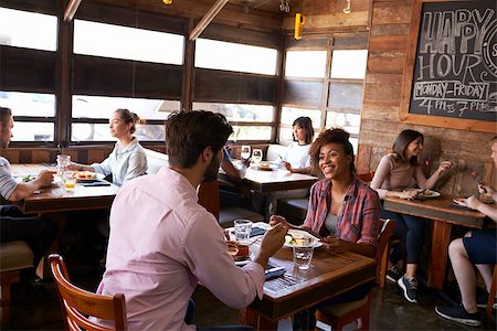 restaurant interior chalkboard - Mixed race couple enjoying lunch in a busy restaurant Stock Photo - Budget Royalty-Free & Subscription, Code: 400-08839278