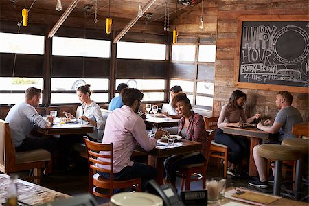 restaurant interior chalkboard - Couples enjoying lunch at a busy restaurant Stock Photo - Budget Royalty-Free & Subscription, Code: 400-08839281