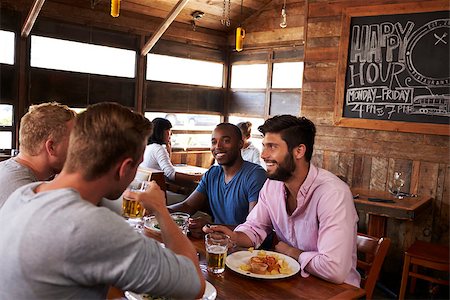 simsearch:400-08937692,k - Four male friends at lunch together in restaurant, close up Stock Photo - Budget Royalty-Free & Subscription, Code: 400-08839295