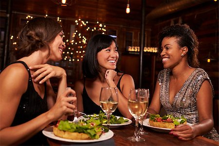 friends table indoor dinner - Three female friends eating dinner together at a restaurant Stock Photo - Budget Royalty-Free & Subscription, Code: 400-08839335