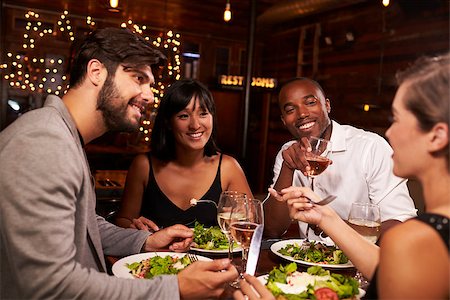 friends table indoor dinner - Four friends enjoying dinner and drinks at a restaurant Stock Photo - Budget Royalty-Free & Subscription, Code: 400-08839330