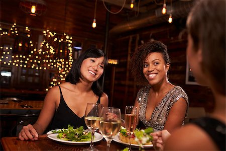 friends table indoor dinner - Three female friends enjoying dinner at a restaurant Stock Photo - Budget Royalty-Free & Subscription, Code: 400-08839332