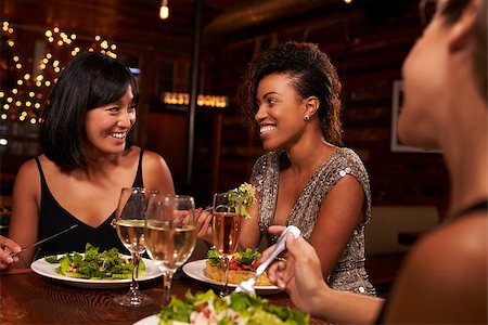 friends table indoor dinner - Three female friends enjoying dinner at a restaurant Stock Photo - Budget Royalty-Free & Subscription, Code: 400-08839333