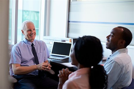 financial advisor talking to couple - Doctor In Consultation With Couple In Office Stock Photo - Budget Royalty-Free & Subscription, Code: 400-08839358