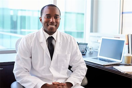 Portrait Of Doctor Wearing White Coat In Office Stock Photo - Budget Royalty-Free & Subscription, Code: 400-08839438