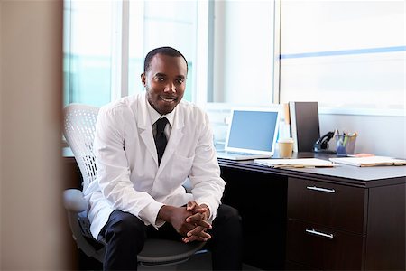 Portrait Of Doctor Wearing White Coat In Office Stock Photo - Budget Royalty-Free & Subscription, Code: 400-08839439