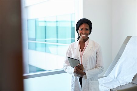 Portrait Of Female Doctor With Digital Tablet In Exam Room Stock Photo - Budget Royalty-Free & Subscription, Code: 400-08839463