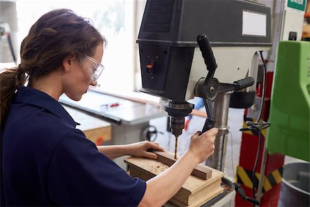 Female Engineer Using Drill In Factory Stock Photo - Budget Royalty-Free & Subscription, Code: 400-08839509