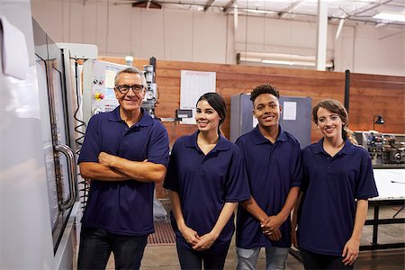 female factory worker looking at camera - Portrait Of Engineer Training Apprentices On CNC Machine Stock Photo - Budget Royalty-Free & Subscription, Code: 400-08839520