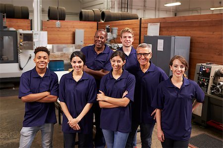 female factory worker looking at camera - Portrait Of Engineers And Apprentices In Busy Factory Stock Photo - Budget Royalty-Free & Subscription, Code: 400-08839540