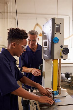 pictures of black men working in factory - Carpenter Training Male Apprentice To Use Mechanized Saw Stock Photo - Budget Royalty-Free & Subscription, Code: 400-08839550